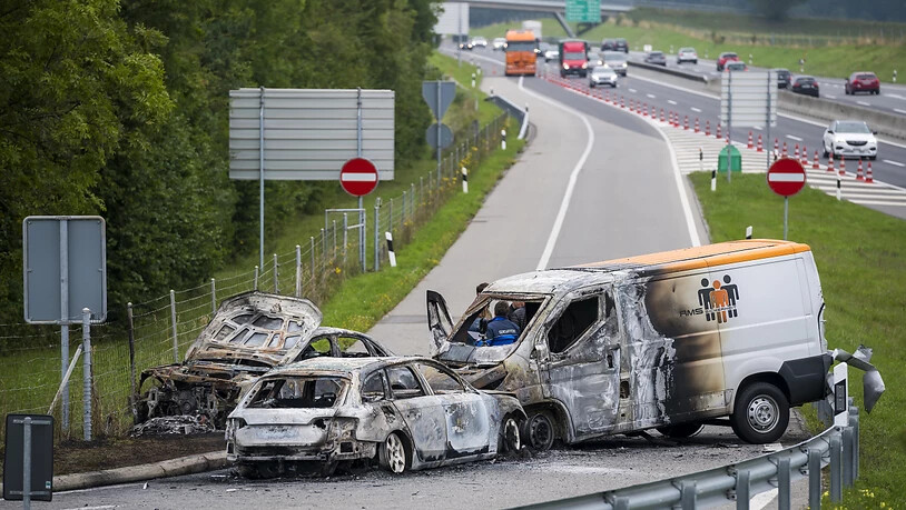 Drei Fahrzeuge brannten nach dem Überfall auf einen Geldtransporter auf der Ausfahrt der Autobahn A1 bei La Sarraz aus.
