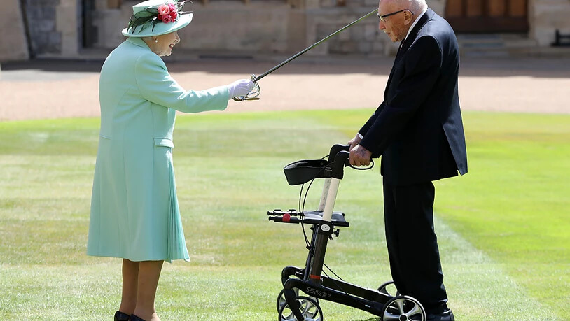 dpatopbilder - Königin Elizabeth II. (l) schlägt Tom Moore (r), Weltkriegsveteran und Rekord-Spendensammler, während einer Zeremonie im Freien auf Schloss Windsor zum Ritter. Foto: Chris Jackson/PA Wire/dpa