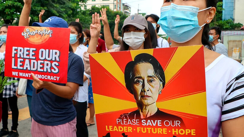 Anti-Putsch-Demonstranten in Yangon halten ein Plakat mit dem Bild der festgesetzten Regierungschefin Aung San Suu Kyi hoch. (Archivbild) Foto: Uncredited/AP/dpa