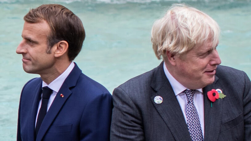 Emmanuel Macron, Präsident von Frankreich, und Boris Johnson, Premierminister von Großbritannien, sind wegen des Fischereistreits uneins. Foto: Oliver Weiken/dpa
